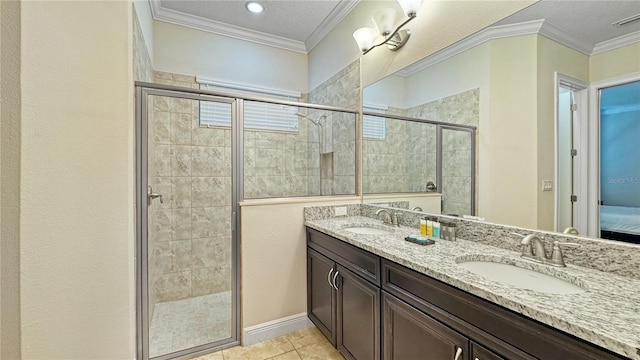 bathroom with tile patterned floors, vanity, a shower with shower door, and ornamental molding