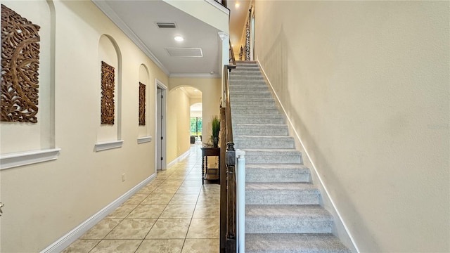 stairs featuring crown molding and tile patterned flooring