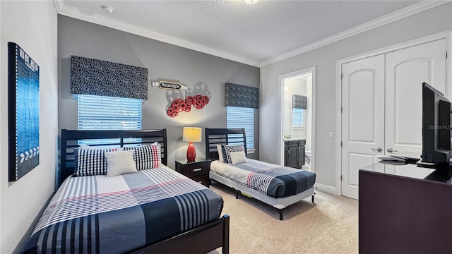 carpeted bedroom featuring ensuite bathroom, crown molding, a textured ceiling, and a closet