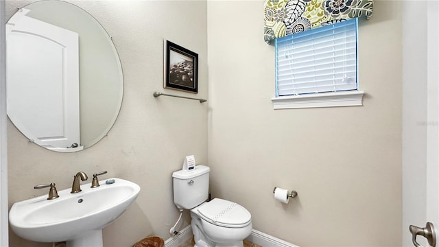 bathroom featuring toilet and sink