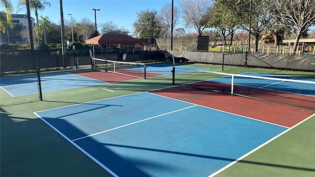 view of tennis court featuring basketball hoop