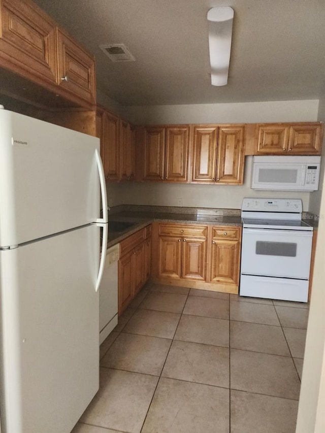 kitchen featuring white appliances and light tile patterned floors