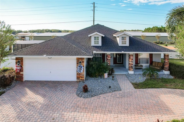 view of front of property featuring a porch and a garage