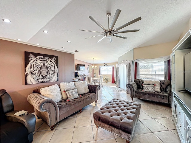 tiled living room featuring a textured ceiling, ceiling fan, and lofted ceiling