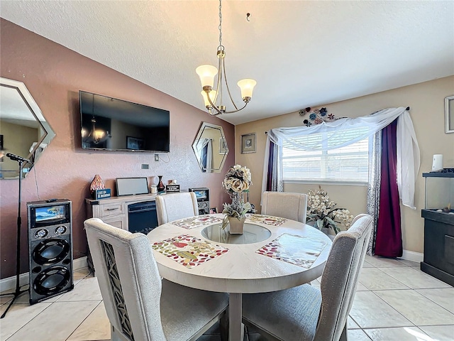 tiled dining room featuring a chandelier and vaulted ceiling