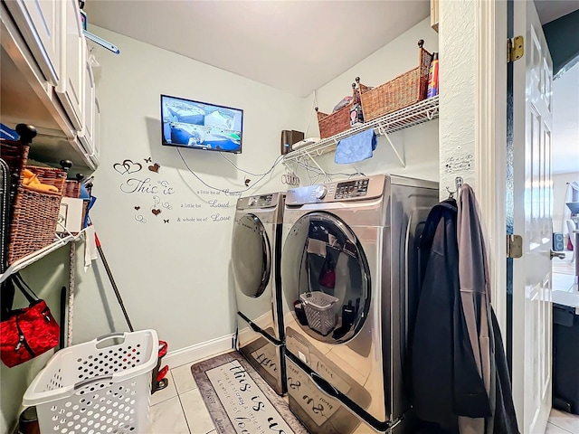 clothes washing area with cabinets, light tile patterned floors, and separate washer and dryer