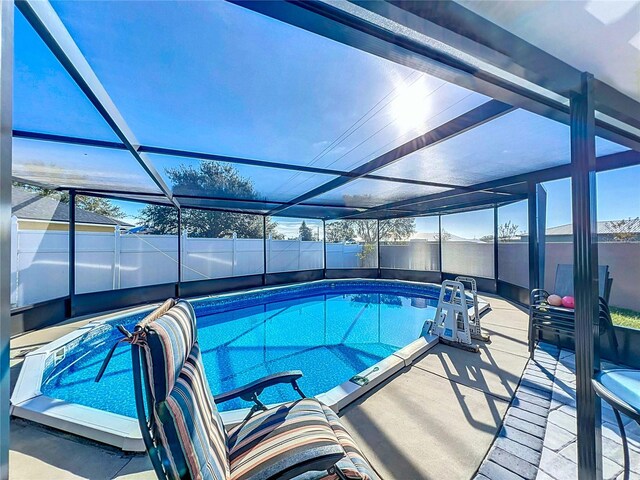 view of swimming pool with a lanai