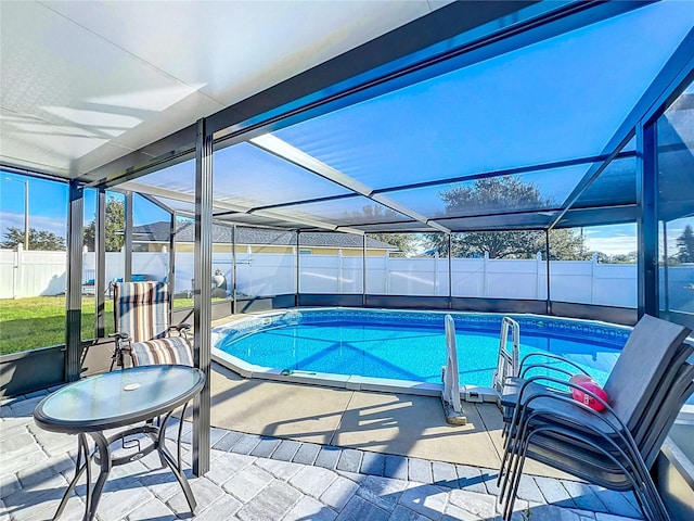 view of swimming pool with a patio and glass enclosure