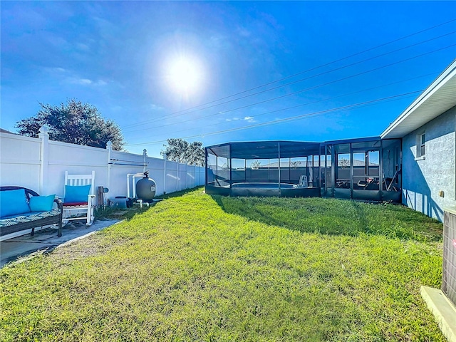 view of yard featuring a sunroom and a patio