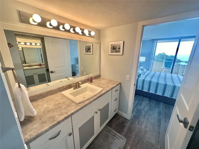 bathroom with vanity, a textured ceiling, and hardwood / wood-style flooring