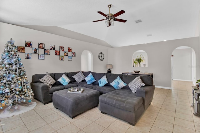 tiled living room with ceiling fan and vaulted ceiling