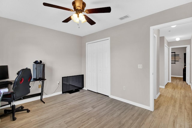 office space with ceiling fan and light hardwood / wood-style flooring