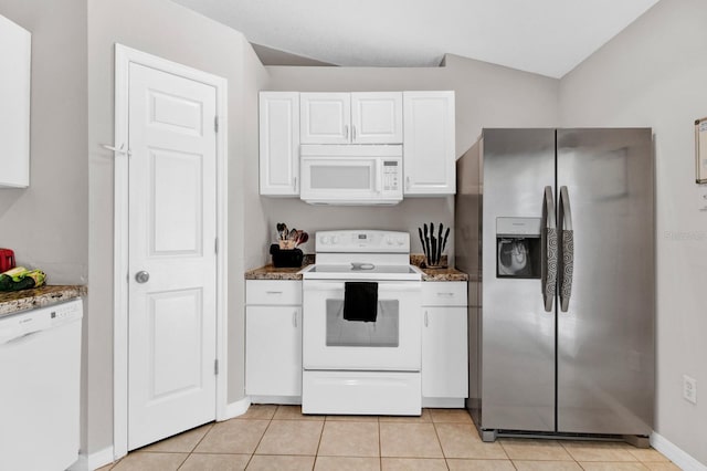 kitchen featuring white appliances, stone countertops, white cabinetry, lofted ceiling, and light tile patterned flooring