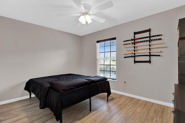 bedroom featuring ceiling fan and light hardwood / wood-style floors