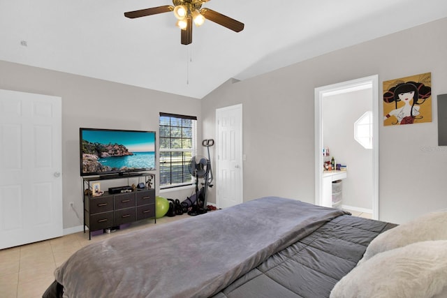 bedroom with ceiling fan, light tile patterned flooring, ensuite bathroom, and vaulted ceiling