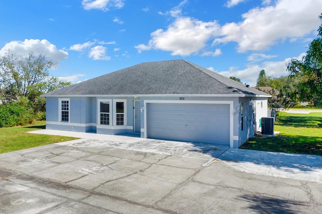 single story home with cooling unit, a garage, and a front lawn