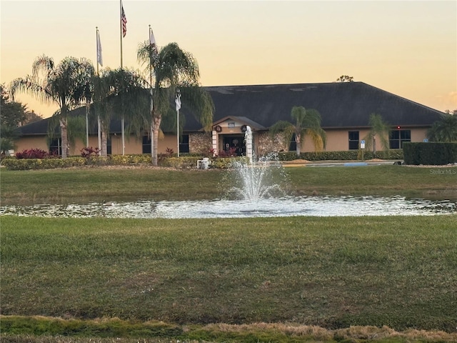 view of front of home featuring a yard and a water view