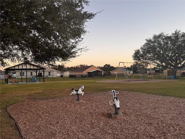 surrounding community featuring a playground and a lawn