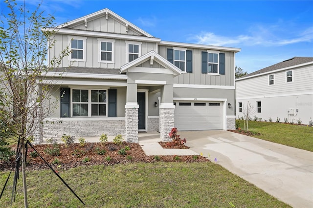 craftsman-style home featuring a front lawn and a garage