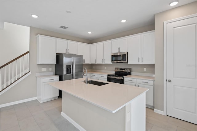 kitchen with sink, white cabinets, an island with sink, and appliances with stainless steel finishes