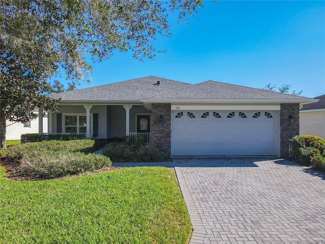 ranch-style house with a garage and a front yard