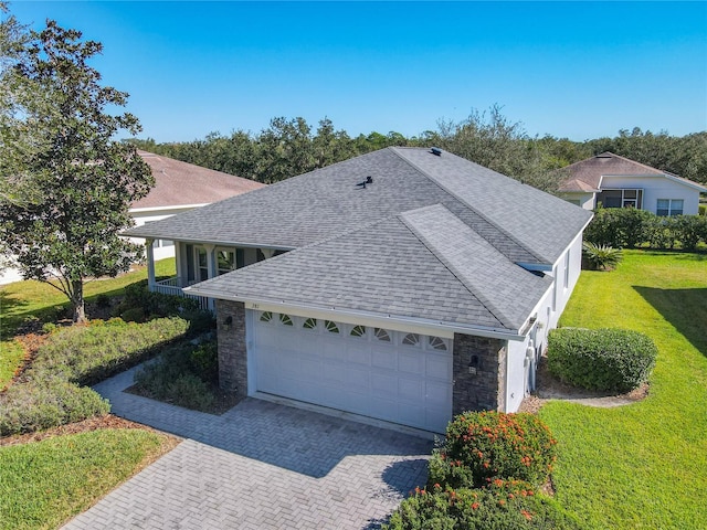 view of side of property with a yard and a garage