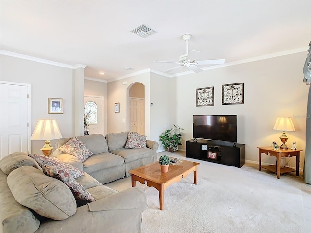 carpeted living room with ceiling fan and crown molding