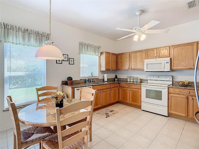 kitchen with decorative light fixtures, white appliances, sink, and light tile patterned floors