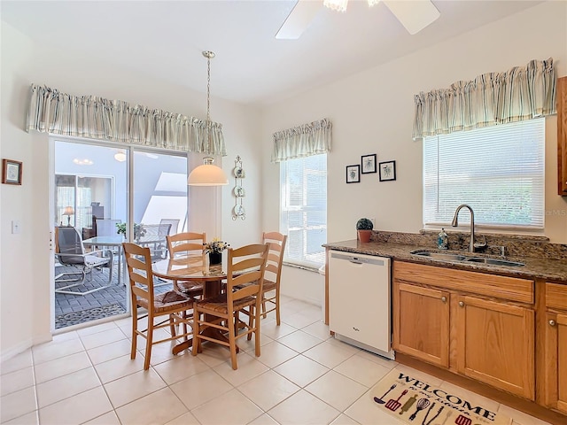 dining room with ceiling fan, sink, and light tile patterned flooring