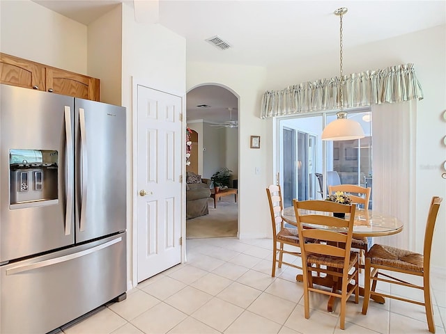 tiled dining area with ceiling fan