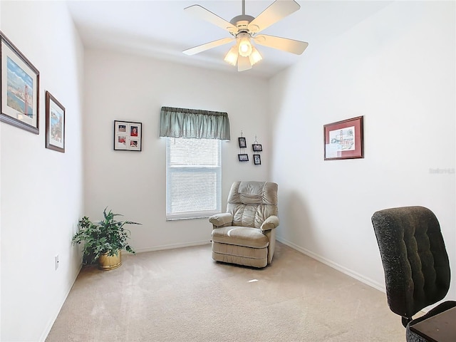 sitting room featuring carpet and ceiling fan