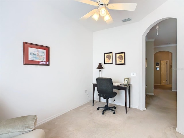 office space with crown molding, ceiling fan, and light colored carpet