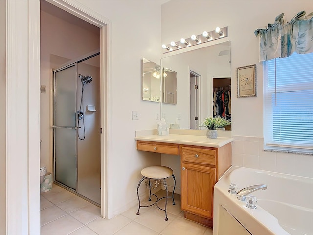 bathroom with vanity, tile patterned flooring, and plus walk in shower