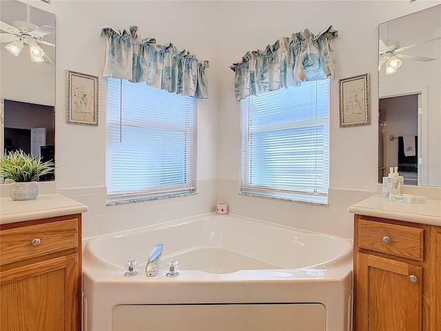 bathroom featuring a bath, vanity, and ceiling fan