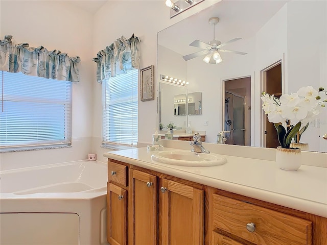 bathroom featuring separate shower and tub, ceiling fan, and vanity