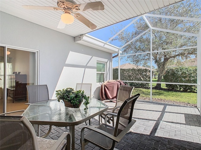 sunroom / solarium featuring a wealth of natural light, ceiling fan, and vaulted ceiling