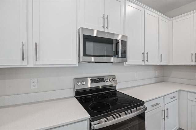 kitchen with white cabinetry and appliances with stainless steel finishes