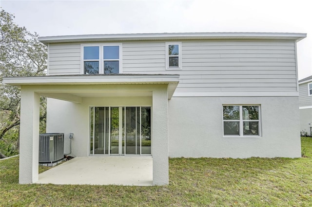 back of house with a yard, central AC unit, and a patio area