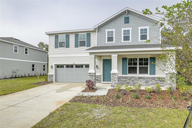 view of front of property featuring a porch, a garage, and a front lawn