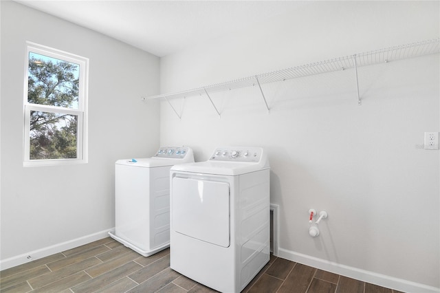 clothes washing area with independent washer and dryer and plenty of natural light