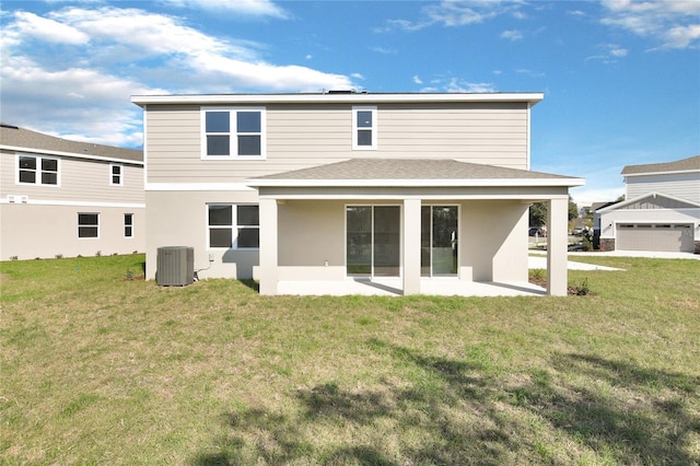 back of property with a lawn, a patio area, and central air condition unit