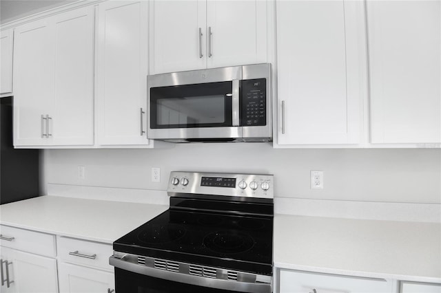 kitchen featuring white cabinets and appliances with stainless steel finishes