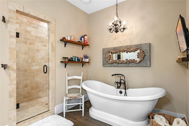 bathroom featuring hardwood / wood-style floors, independent shower and bath, and an inviting chandelier