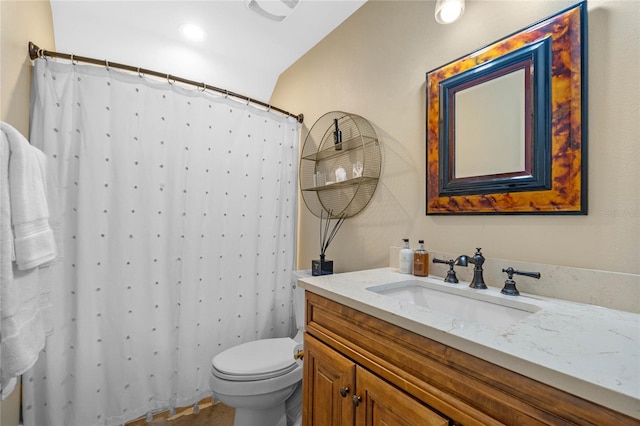 bathroom with vanity, curtained shower, and toilet