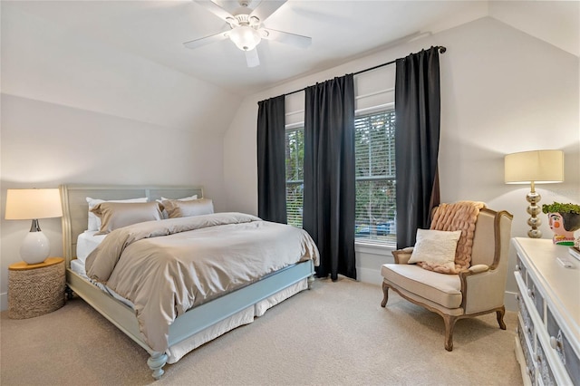 bedroom with light carpet, vaulted ceiling, and ceiling fan