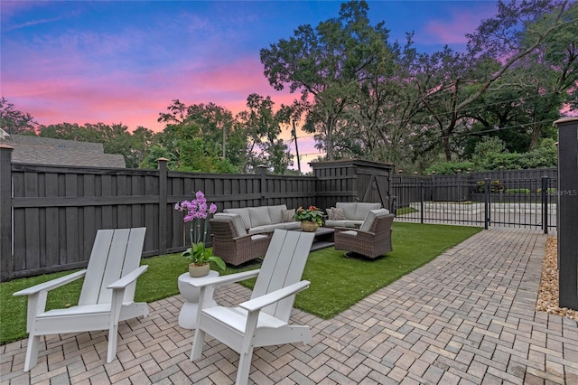 patio terrace at dusk featuring an outdoor living space