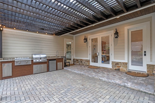 view of patio / terrace featuring area for grilling, french doors, and an outdoor kitchen