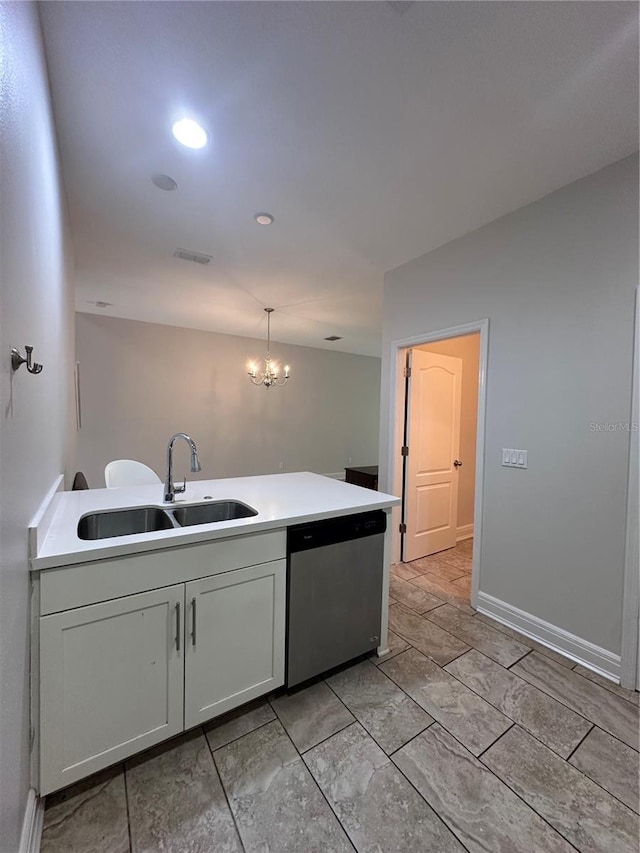 kitchen featuring hanging light fixtures, dishwasher, sink, and white cabinetry