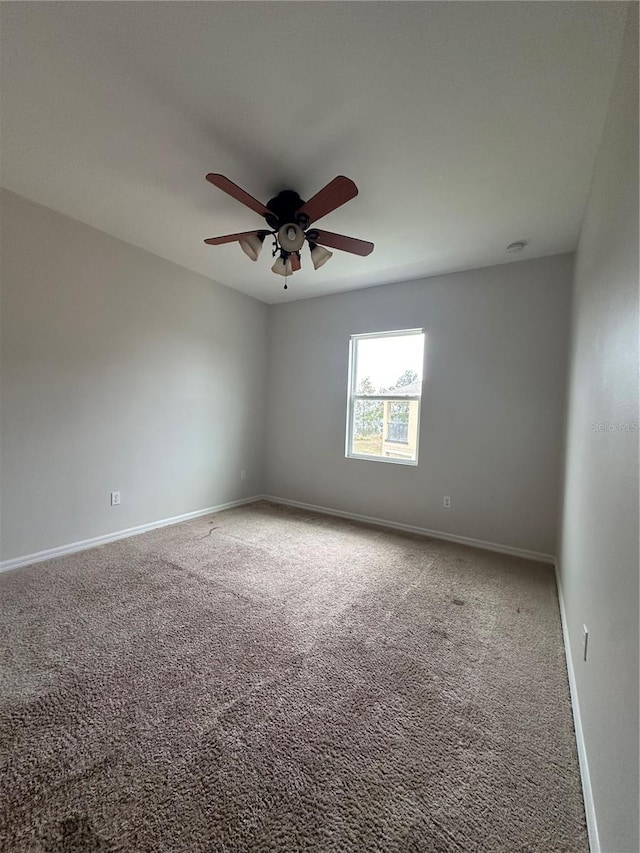 spare room featuring carpet floors and ceiling fan