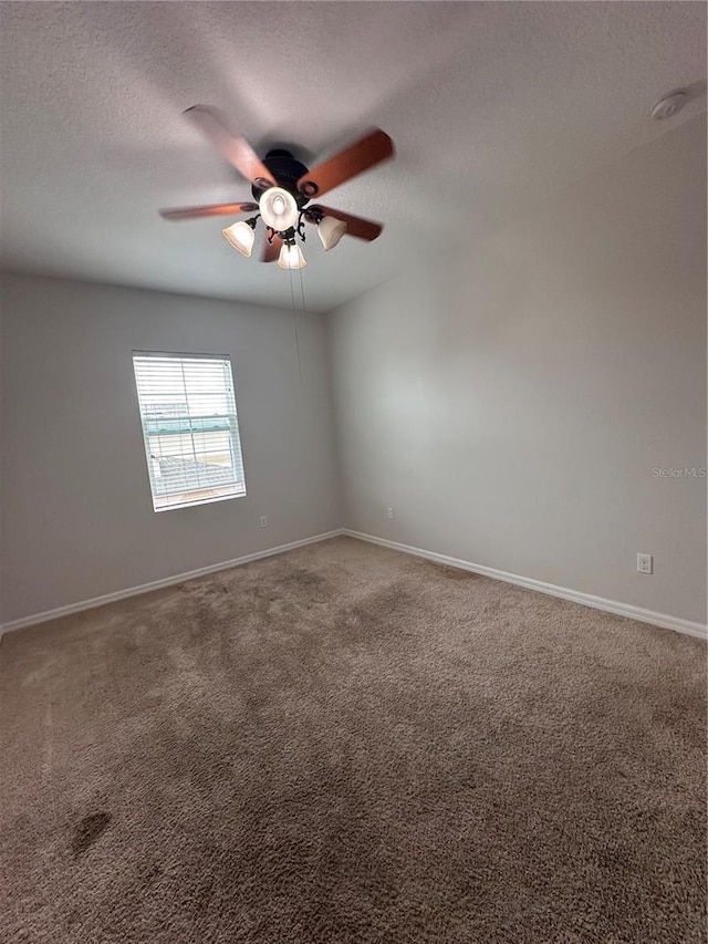 spare room with carpet floors and ceiling fan